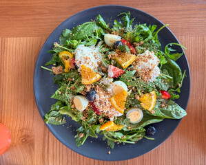A vibrant salad featuring fresh greens, fruits, and nuts, perfect for a healthy meal.
