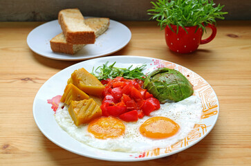 Healthy breakfast of sunny-side up with microgreen and colorful veggie salad