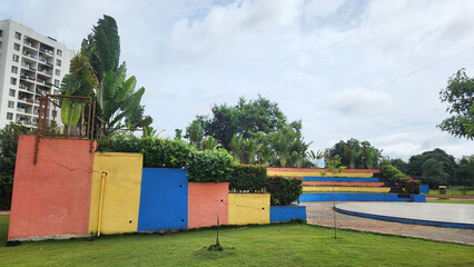 colorful wall with greenary  surrounded , beautiful park view of urban city