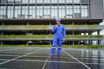 Electrical engineer inspecting and installing a solar panels on the building rooftop.