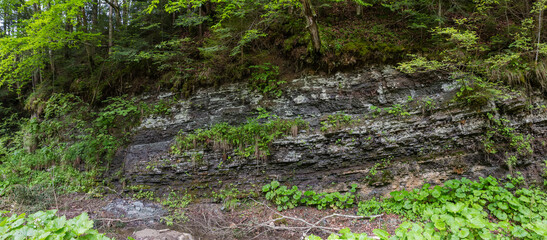Fototapeta premium Part of mountain slope with layered structure outcrop of rocks