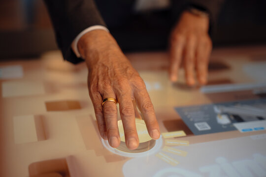 Businessman using interactive touchscreen in a modern office