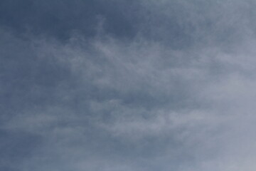 A clear, pale blue daytime sky with wispy, faint clouds scattered across it.
