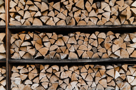 Stacked firewood wall showcasing eco living and sustainability