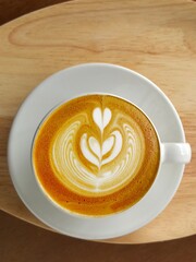  a cup of latte art coffee on wooden background                                                                                                                                                         