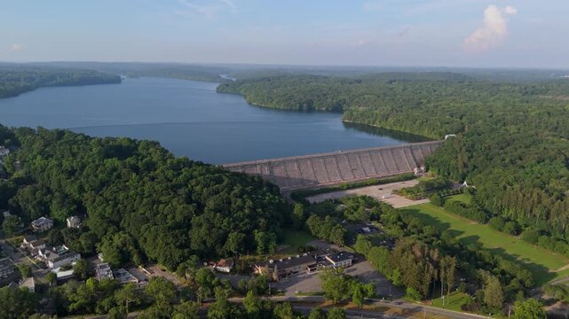 Kensico Dam and Reservoir, town of Valhalla below, surrounded by green summer forest in Westchester County, New York, USA