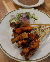 Grilled skewers served with vegetables and sauce.