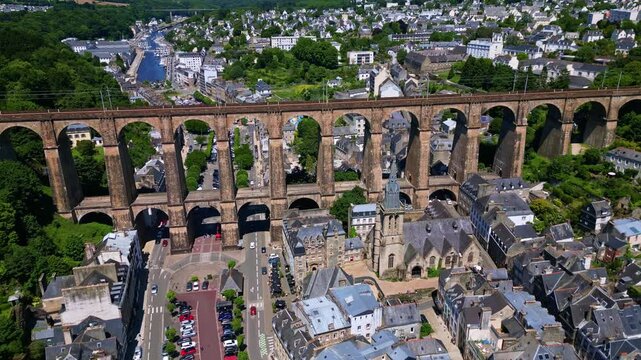 The drone pulls back above the rooftops, revealing Saint-Melaine Church, the Morlaix Viaduct, and the city surrounding them. Brittany in France