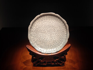 close view to the white porcelain with crackle glaze under the light in the museum for show