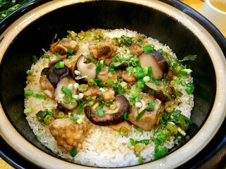 Traditional Chinese Claypot Rice with Braised Pork Ribs and Shiitake Mushrooms in Ceramic Bowl, Asian Comfort Food
 