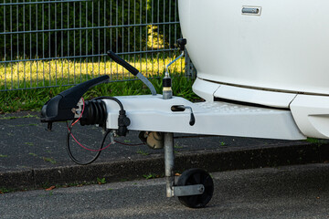 Trailer hitch attachment on a sunny day in a park.