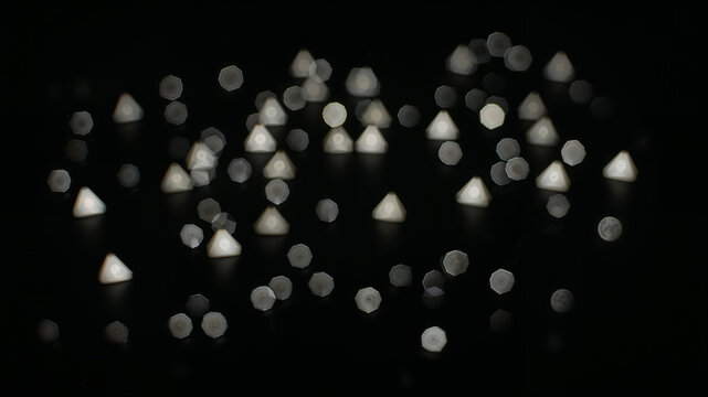 Triangular bokeh lights creating a festive atmosphere on dark background