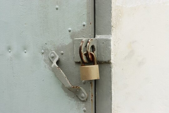 Old rusty steel door and padlock background