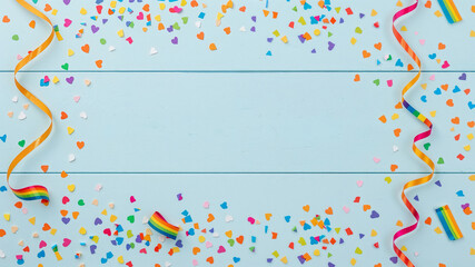 Rainbow ribbons and confetti creating festive pride celebration background