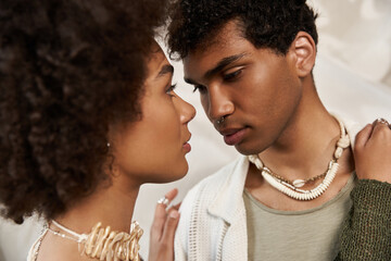 Young couple sharing an intimate gaze in a stylish and aesthetic setting filled with love