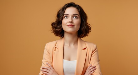Obraz premium Portrait of Confident Young Woman in Peach Blazer Looking Upward
