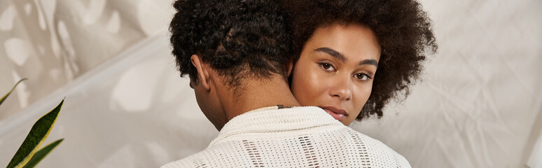 Young couple enjoying a tender moment together surrounded by stylish decor in a cozy setting