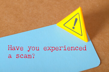 Have You Experienced a Scam? – Red Alert Warning Sign on Notecard Sparks Online Fraud Awareness