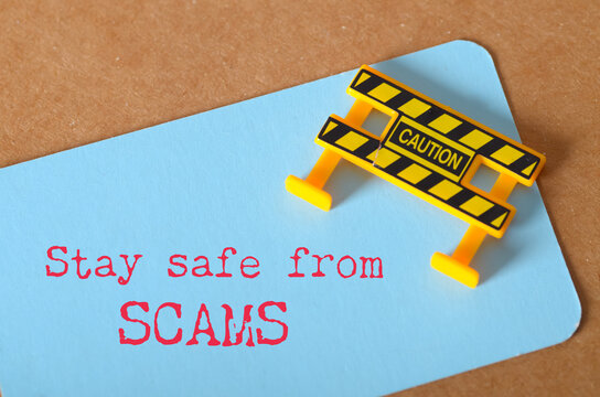 Stay Safe from Scams – Caution Message on Note Card to Warn Against Fraudulent Activities