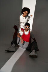 Young couple showcasing love and style in a modern, minimalist setting during daylight hours