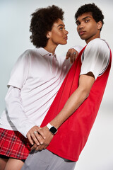 Stylish young couple embraces in a playful moment filled with love and connection