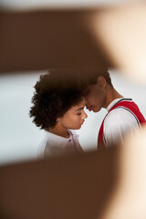Young couple sharing a tender moment in a stylish and bright setting filled with love
