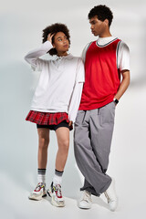 Young couple showcasing modern style and love in a minimalist studio setting