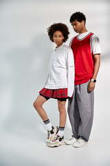 Stylish young couple embracing love in a creative fashion studio setting