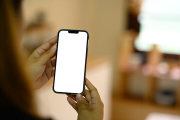 Hands using mobile phone with warm kitchen background