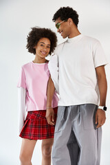 Young couple expressing love in a stylish, playful moment during an indoor photo shoot together