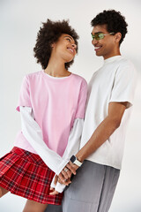 Stylish young couple sharing a loving moment in casual chic attire indoors