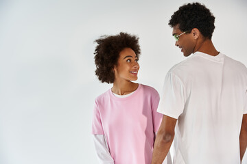 Young couple enjoying a lighthearted moment together in stylish casual attire