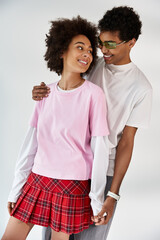 Young couple shares joyful moments in stylish outfits, radiating love and happiness together