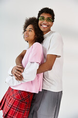 Young couple radiating love and style in a chic studio setting