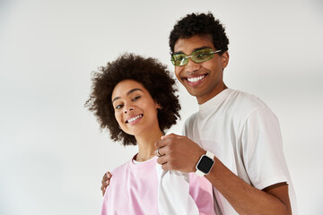 Young couple enjoying a playful moment in stylish outfits, radiating love and joy together