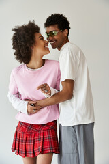 Stylish young couple sharing intimate moments in a cozy indoor setting filled with love