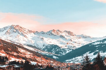 Fototapeta premium Snowy mountain range at dawn. Alpine peaks covered in fresh snow, nestled valleys, and colorful sunrise hues. Cozy village nestled in the foothills