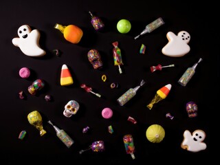 Halloween candy and treats flat lay on dark background