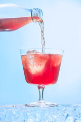 Refreshing Pink Beverage Pouring into Glass