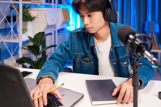 Podcaster writing notes while recording