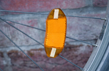 Reflector attached to bicycle spokes enhances visibility and safety while riding in urban areas