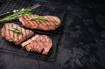 Grilled Top blade steak, shoulder beef meat. black background. top view