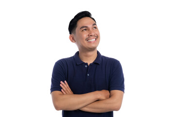 Smiling Asian man crossing arms and looking up with confident and optimistic expression isolated on...