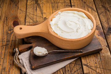 Italian Mascarpone cheese, cream cheese for tiramisu. wooden background. top view