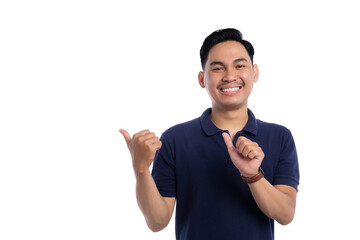 Smiling Asian man pointing to his side with both hands and friendly expression isolated on...