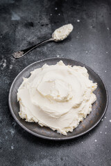 Creamy Homemade Mascarpone cheese, cream cheese. black background. top view