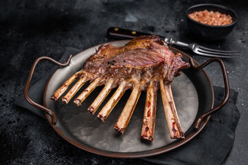 Roast Rack of lamb chops, mutton organic meat. black background. top view