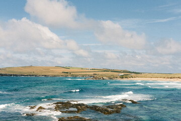 Surfers at Constantine Bay in summer, Cornwall UK