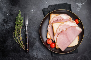 Ham sandwich, toast with sliced Prosciutto Cotto. black background. top view © Mironov