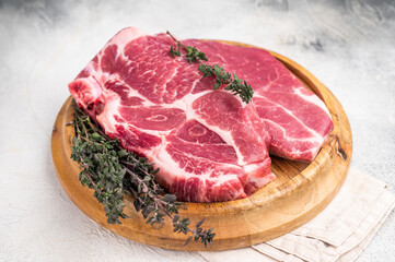 Raw pork tender neck steak, fresh meat. grey background. top view